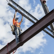 Ironworker at construction site installing roof joist Construction small business lending kapitus