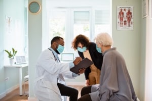 Close up of a senior woman and her daughter having a doctors appointment