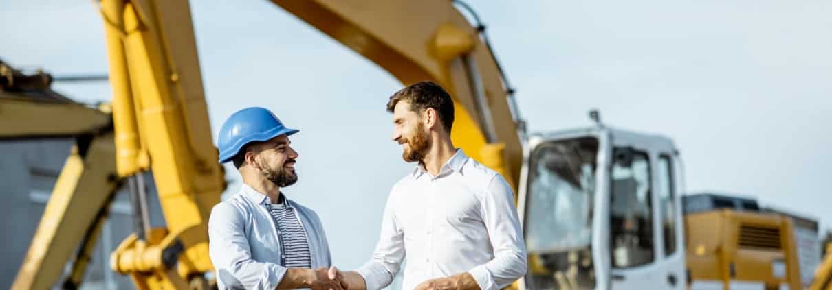 Handshake in front of crane