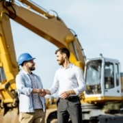 Handshake in front of crane