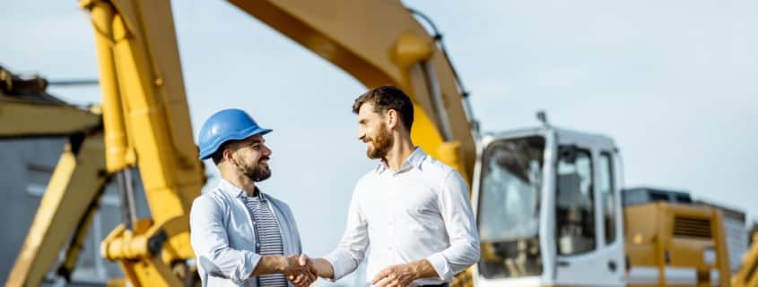 Handshake in front of crane